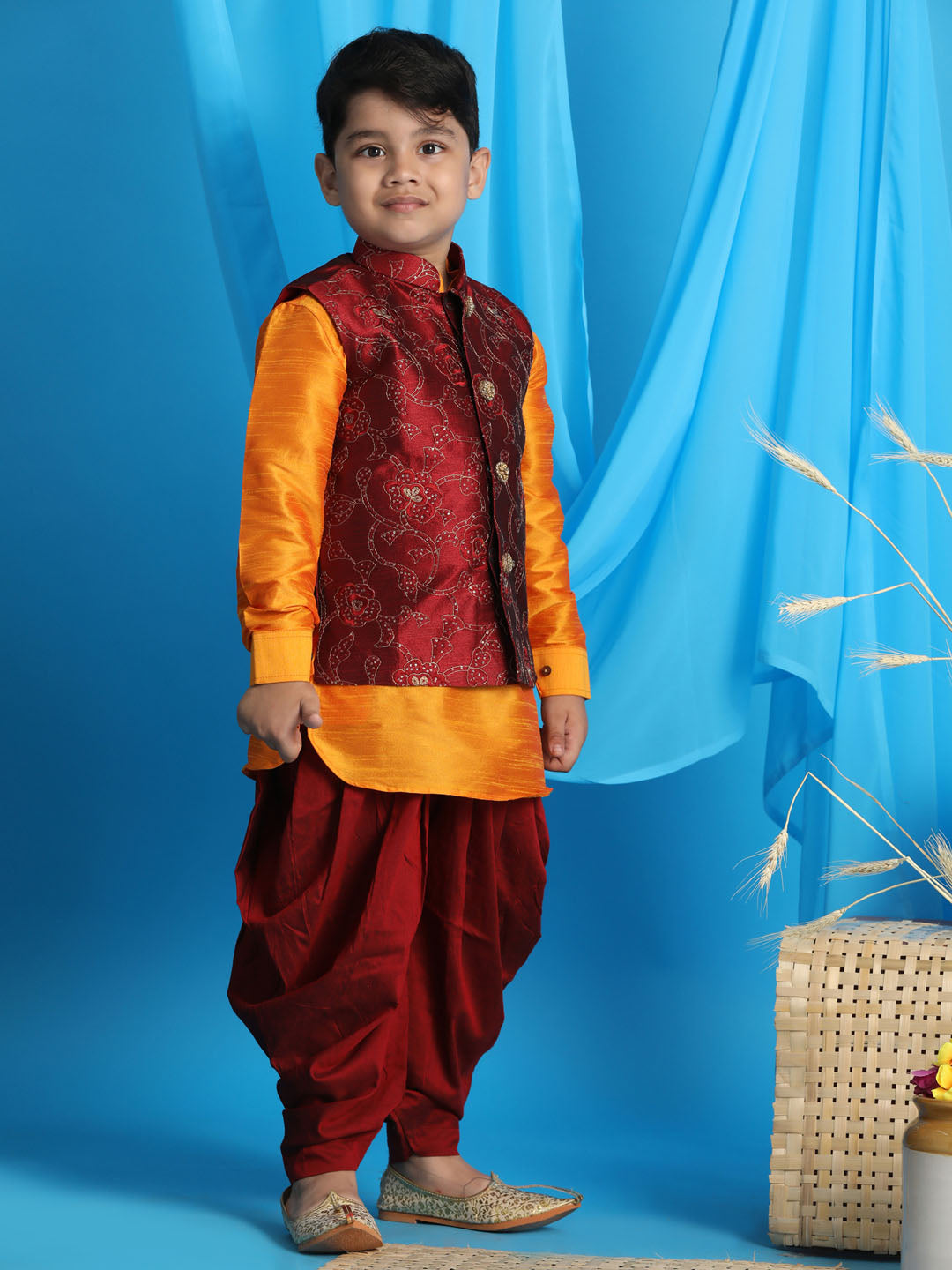 Vastramay boys maroon embroidered nehru jacket with orange kurta and black dhoti set