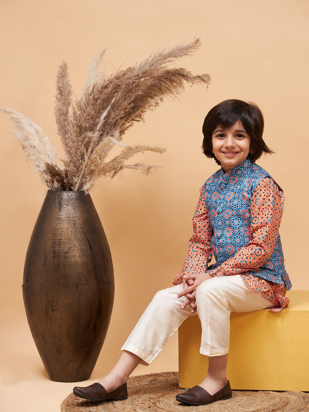 Vastramay boys orange printed kurta and cream pyjama set with blue nehru jacket