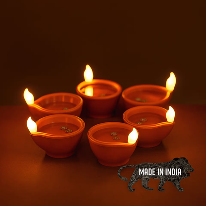 Traditional brown LED water diyas glowing against a dark background